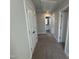 Hallway features neutral carpet and white doors, leading to various rooms at 773 Portland Rose Dr, Knightdale, NC 27545