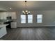 Open concept living space adjoining a modern kitchen with recessed lighting and large windows at 773 Portland Rose Dr, Knightdale, NC 27545