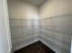 Walk-in pantry features ample shelving and dark wood floors at 773 Portland Rose Dr, Knightdale, NC 27545