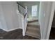 Carpeted staircase with white railing and natural light from a window at 773 Portland Rose Dr, Knightdale, NC 27545
