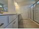 Well-lit bathroom featuring sleek cabinetry, quartz countertops, and a glass-enclosed shower at 79 Mildred Dr, Broadway, NC 27505