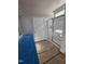 Well-lit bathroom featuring a glass-enclosed shower, white cabinets, and granite countertops at 79 Mildred Dr, Broadway, NC 27505
