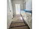 Bright bathroom with white cabinetry, granite countertops, and decorative tile flooring at 79 Mildred Dr, Broadway, NC 27505