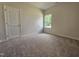 Cozy bedroom with soft carpet, a large window offering natural light, and a neutral color palette at 79 Mildred Dr, Broadway, NC 27505