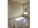 Well-lit bedroom with a door, window, and neutral paint, providing a blank canvas at 79 Mildred Dr, Broadway, NC 27505