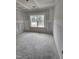 Unfinished bedroom with window overlooking trees, drywall and concrete flooring at 79 Mildred Dr, Broadway, NC 27505