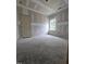 Unfinished bedroom with single window overlooking trees, drywall and concrete flooring at 79 Mildred Dr, Broadway, NC 27505