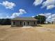 Back exterior view of the home featuring a patio and ample yard space at 79 Mildred Dr, Broadway, NC 27505