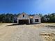New house under construction featuring modern architectural design with a two-car garage on a sunny day at 79 Mildred Dr, Broadway, NC 27505