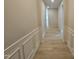 Inviting hallway with decorative wall paneling and wood-look flooring creating a warm and stylish entrance at 79 Mildred Dr, Broadway, NC 27505