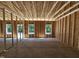 A look at interior framing showcasing the structure and window openings of the new construction house at 79 Mildred Dr, Broadway, NC 27505