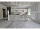 Unfinished kitchen area showcasing island with cabinets and natural light from windows at 79 Mildred Dr, Broadway, NC 27505