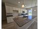 Spacious kitchen features granite countertops, ample white cabinetry, and modern stainless steel appliances at 79 Mildred Dr, Broadway, NC 27505