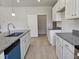 Open-concept kitchen features granite countertops, white cabinets, stainless appliances, and a pantry at 79 Mildred Dr, Broadway, NC 27505