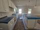 Open-concept kitchen design with a large island, granite countertops, and modern white cabinetry at 79 Mildred Dr, Broadway, NC 27505