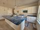 Bright and spacious kitchen featuring white cabinets, granite countertops, and a large island at 79 Mildred Dr, Broadway, NC 27505