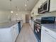 Bright kitchen boasts stainless steel appliances, granite countertops, and a walk-in pantry at 79 Mildred Dr, Broadway, NC 27505