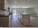Well-lit kitchen with a central island, granite countertops, and stainless steel appliances, perfect for cooking at 79 Mildred Dr, Broadway, NC 27505