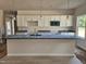Spacious kitchen with white cabinets, granite countertops, a kitchen island, and recessed lighting at 79 Mildred Dr, Broadway, NC 27505