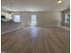 Spacious living area with wood-look floors connecting the kitchen and lots of natural light streaming through windows at 79 Mildred Dr, Broadway, NC 27505