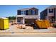 New home under construction with blue and gray siding, featuring a yellow dumpster at 801 Ottawa Dr, Garner, NC 27529