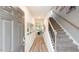 Welcoming entryway featuring wood floors, staircase, and a view into the living and dining areas at 801 Ottawa Dr, Garner, NC 27529