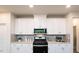 Well-equipped kitchen with white cabinets, modern appliances, and stylish backsplash at 801 Ottawa Dr, Garner, NC 27529