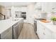 Open kitchen featuring a large island with bar seating, stainless steel appliances, and white cabinetry at 805 Walker Ridge Way, Willow Springs, NC 27592