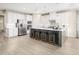 Bright kitchen showcasing a center island with bar stool seating, stainless steel appliances and modern white cabinets at 805 Walker Ridge Way, Willow Springs, NC 27592