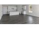 Open concept living and kitchen space features stylish flooring, white cabinets, and a granite island at 832 Old Tarboro Rd, Wendell, NC 27591