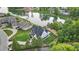 Aerial shot showcases the home with a pool and a scenic lake view in the background at 833 Dunleigh Dr, Burlington, NC 27215