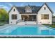 Stunning backyard with a sparkling swimming pool and a beautifully designed white brick home at 833 Dunleigh Dr, Burlington, NC 27215