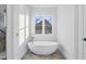 Luxurious bathroom featuring a freestanding tub and a view of the beautiful house at 833 Dunleigh Dr, Burlington, NC 27215