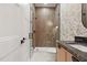 Modern bathroom with glass-enclosed shower and wood-paneled accent wall with stylish vanity at 833 Dunleigh Dr, Burlington, NC 27215