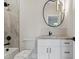 Contemporary bathroom with a round mirror and a tiled shower and bath at 833 Dunleigh Dr, Burlington, NC 27215