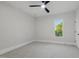 Neutral bedroom with a ceiling fan and a view of the green outdoors at 833 Dunleigh Dr, Burlington, NC 27215