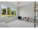 Bright bedroom with large windows, carpet floors, designer seating, and stylish light fixture at 833 Dunleigh Dr, Burlington, NC 27215