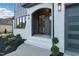Inviting front entryway features white brick, archway, and a gray door with black hardware at 833 Dunleigh Dr, Burlington, NC 27215