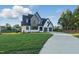Beautiful two-story home with manicured lawn and long driveway leading to the three-car garage at 833 Dunleigh Dr, Burlington, NC 27215