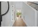 Bright hallway with hardwood floors and view of the living room's chandelier at 833 Dunleigh Dr, Burlington, NC 27215
