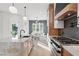 Open-concept kitchen boasts an island with a marble countertop and stainless steel gas range at 833 Dunleigh Dr, Burlington, NC 27215