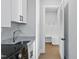 White laundry room featuring modern appliances and a convenient access to a mudroom/storage area at 833 Dunleigh Dr, Burlington, NC 27215
