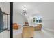 Bright living room featuring large windows, modern light fixture, and comfortable seating at 833 Dunleigh Dr, Burlington, NC 27215