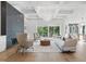 Bright living room with coffered ceiling, modern fireplace, hardwood floors, and large sliding glass doors at 833 Dunleigh Dr, Burlington, NC 27215