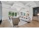 Open-concept living room with modern fireplace and adjacent kitchen at 833 Dunleigh Dr, Burlington, NC 27215