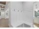 Bright mudroom with built-in bench, storage shelves, and convenient hooks for coats and accessories at 833 Dunleigh Dr, Burlington, NC 27215