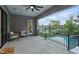 Covered patio offering comfortable seating, scenic lake views, and access to the pool at 833 Dunleigh Dr, Burlington, NC 27215