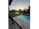 Inviting backyard pool with views of the lake and surrounding neighborhood during sunset at 833 Dunleigh Dr, Burlington, NC 27215