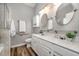 Bathroom featuring double vanity sinks, wood-look flooring, and a walk-in shower at 8437 Whisper Ridge Pl, Raleigh, NC 27613