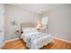 Bedroom featuring a comfortable bed, side tables, and window with blinds at 8437 Whisper Ridge Pl, Raleigh, NC 27613